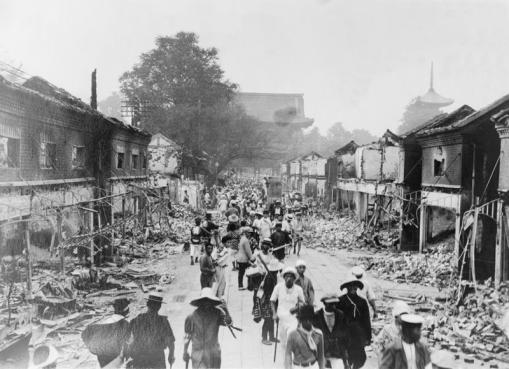 People walking through the ruins of a Tokyo street